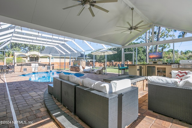 view of patio / terrace featuring area for grilling, ceiling fan, glass enclosure, and an outdoor bar