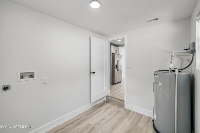 laundry area with electric water heater, hookup for a washing machine, hookup for an electric dryer, and light wood-type flooring