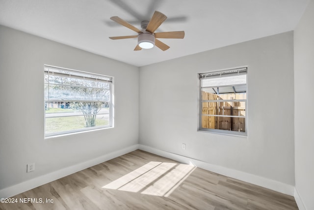 spare room featuring light hardwood / wood-style floors and ceiling fan