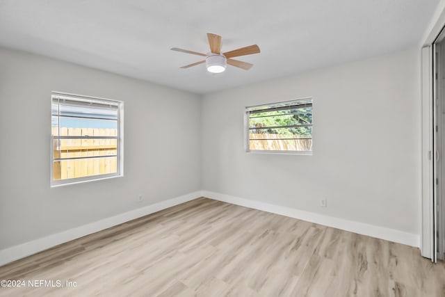 spare room featuring light hardwood / wood-style flooring and ceiling fan