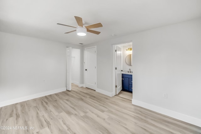 unfurnished bedroom with connected bathroom, ceiling fan, sink, and light hardwood / wood-style floors