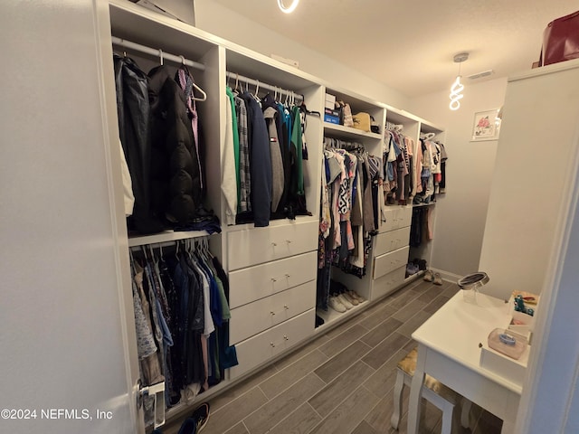 walk in closet featuring dark hardwood / wood-style flooring