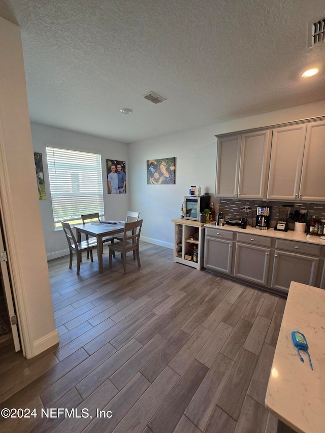 dining space with a textured ceiling and dark hardwood / wood-style floors