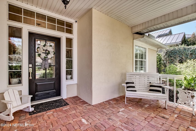 doorway to property featuring a porch