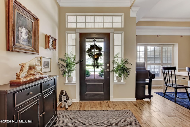 entrance foyer with crown molding and light wood-type flooring