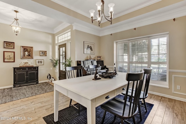 dining room with a chandelier, light hardwood / wood-style floors, and ornamental molding