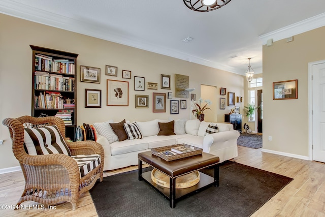 living room featuring crown molding and light hardwood / wood-style floors