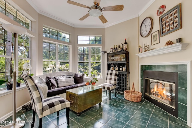 sunroom / solarium with ceiling fan and a tile fireplace