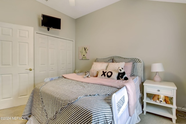 carpeted bedroom with ceiling fan, a closet, and lofted ceiling