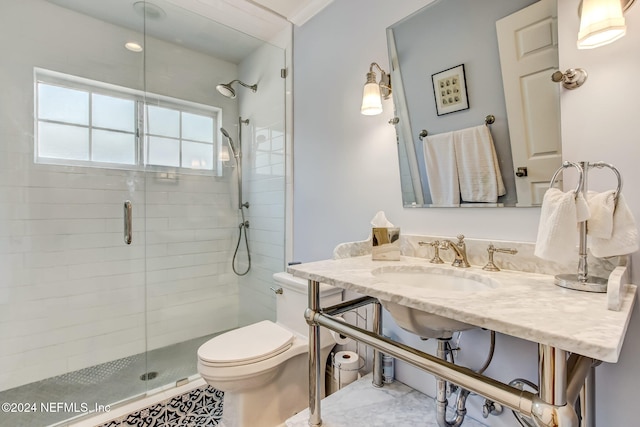 bathroom with toilet, ornamental molding, sink, and walk in shower