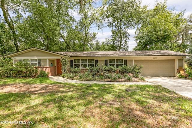 ranch-style home featuring a garage and a front yard