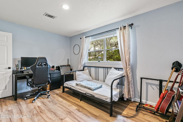 office space featuring hardwood / wood-style flooring and a textured ceiling