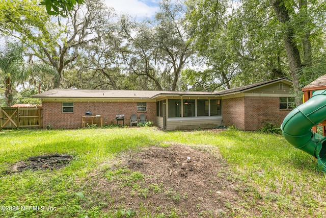 rear view of house with a playground