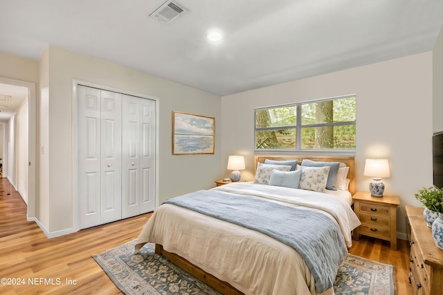 bedroom with hardwood / wood-style flooring and a closet