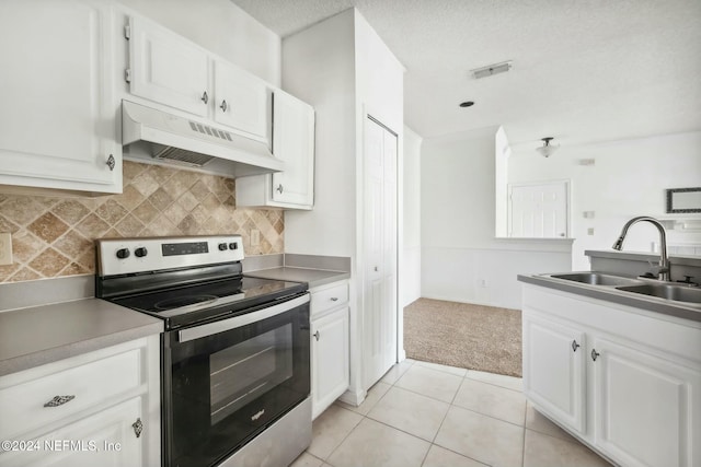 kitchen featuring sink, light tile patterned floors, electric stove, white cabinets, and custom exhaust hood