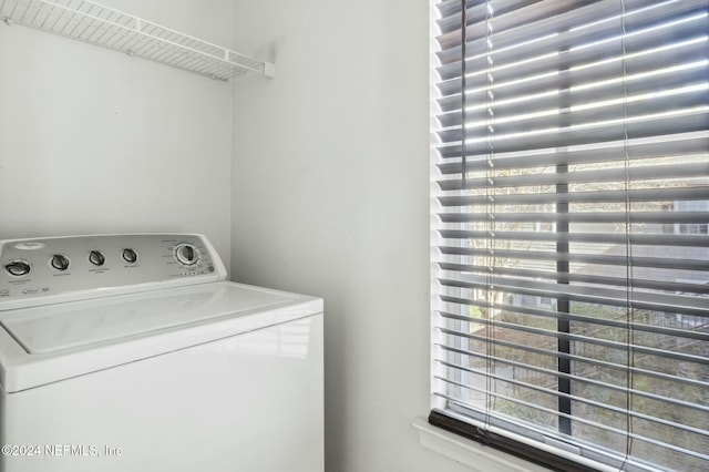 clothes washing area with washer / dryer