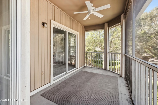 unfurnished sunroom with ceiling fan