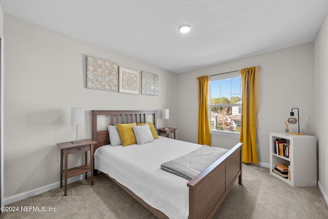 carpeted bedroom with a textured ceiling