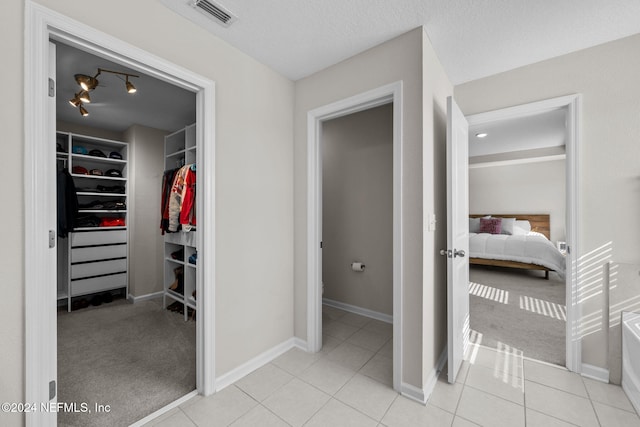 interior space with tile patterned floors and a textured ceiling