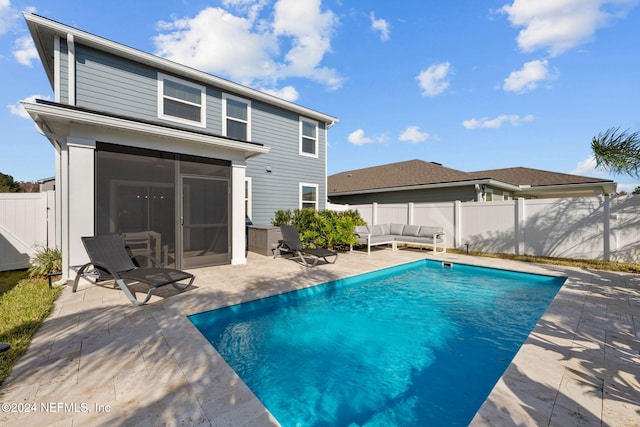 view of pool featuring a sunroom and a patio