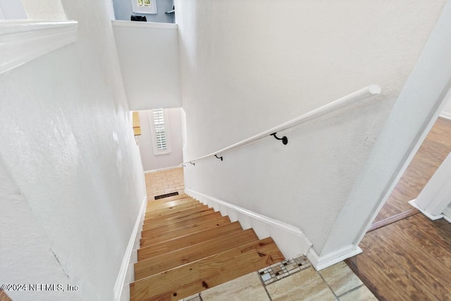 stairway with hardwood / wood-style flooring