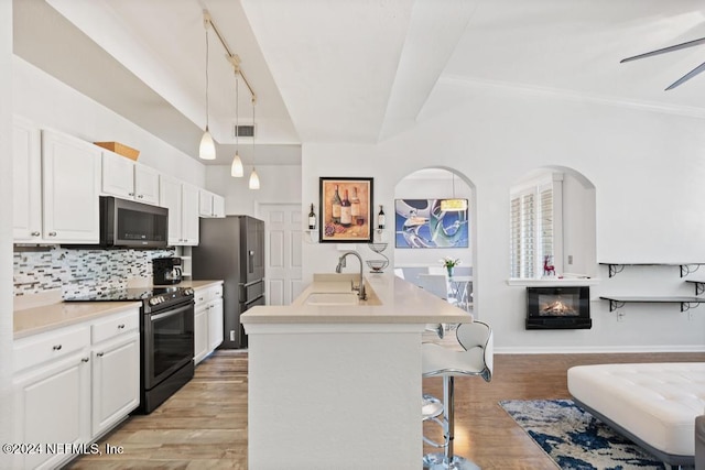 kitchen featuring sink, white cabinets, light hardwood / wood-style floors, and appliances with stainless steel finishes