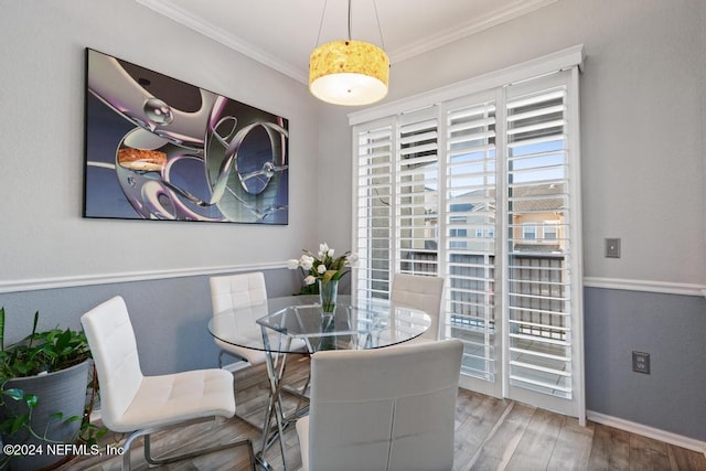 dining room with hardwood / wood-style floors and ornamental molding