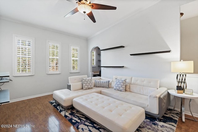 living room featuring dark hardwood / wood-style floors, vaulted ceiling, ceiling fan, and crown molding