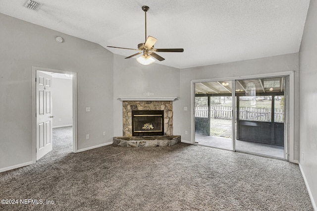 unfurnished living room featuring carpet flooring, ceiling fan, a fireplace, and vaulted ceiling