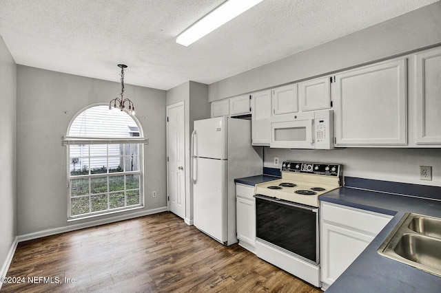 kitchen featuring hanging light fixtures, dark wood-type flooring, a notable chandelier, white appliances, and white cabinets