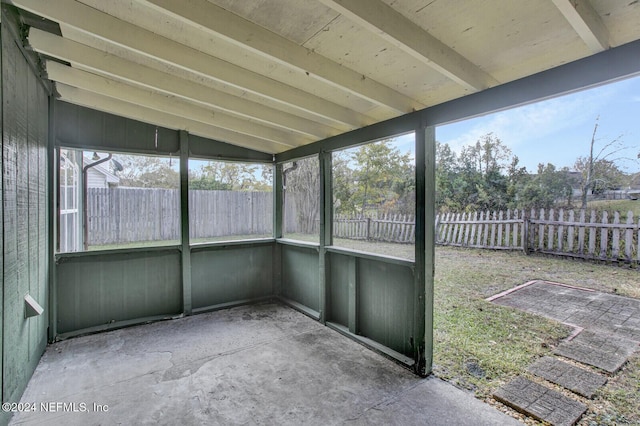 unfurnished sunroom featuring lofted ceiling