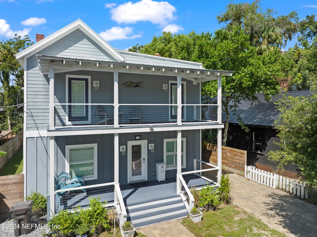 view of front of house featuring a balcony