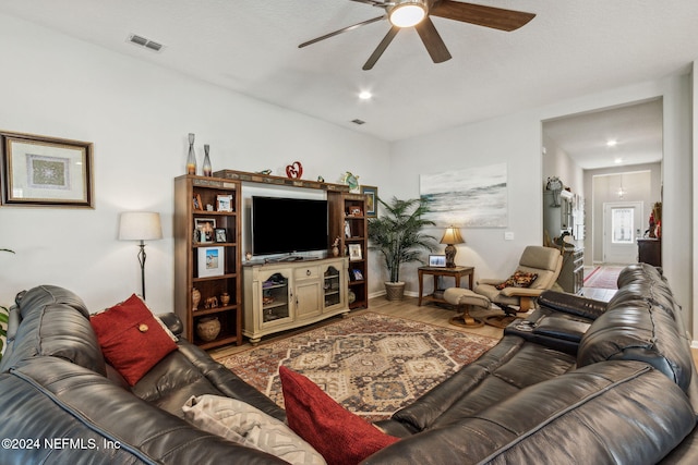 living room with ceiling fan and hardwood / wood-style floors