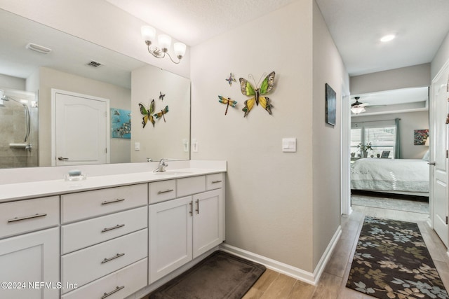 bathroom with ceiling fan, wood-type flooring, and vanity