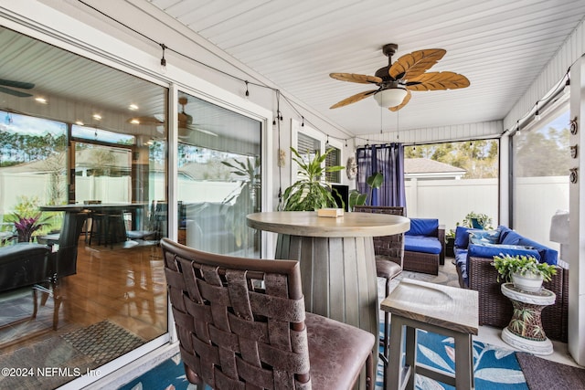 sunroom / solarium with ceiling fan and wooden ceiling