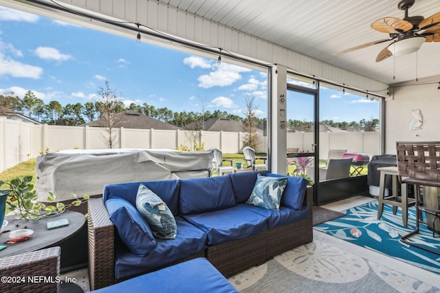 sunroom / solarium featuring ceiling fan