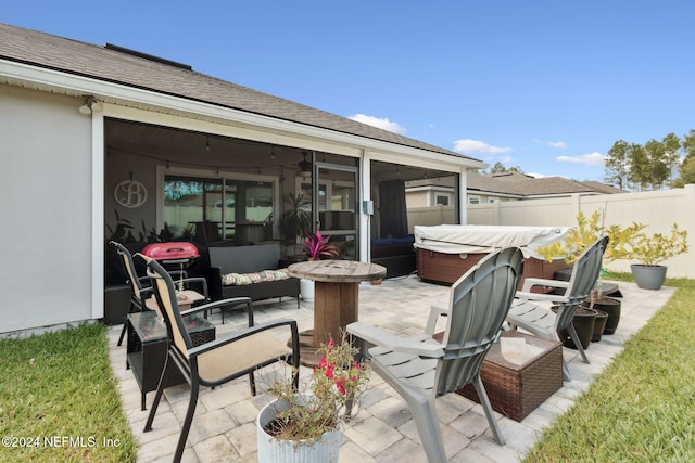 view of patio with an outdoor living space and a hot tub