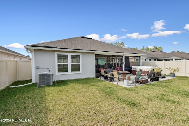 rear view of property with outdoor lounge area, a patio, a yard, and central AC