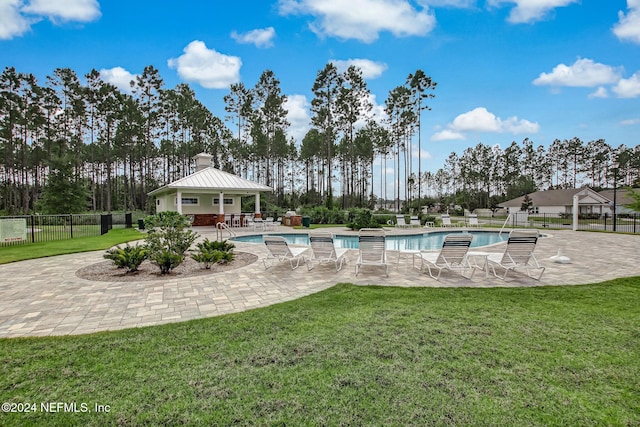 view of pool featuring a yard and a patio