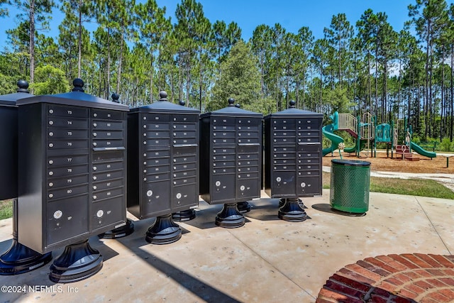 view of home's community featuring a playground and mail boxes