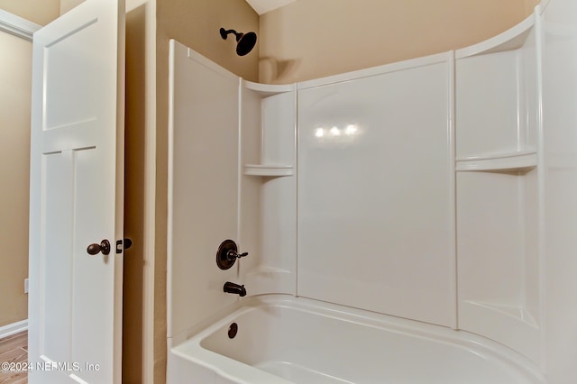 bathroom featuring hardwood / wood-style flooring and shower / bathtub combination