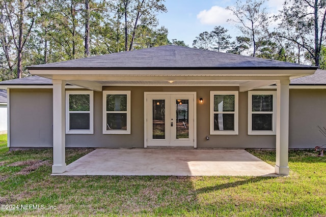 rear view of house featuring a patio area and a yard