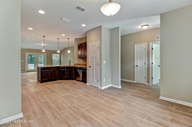 kitchen with dishwasher, sink, and light hardwood / wood-style floors