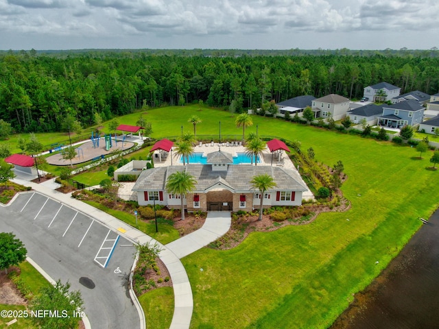 drone / aerial view with a wooded view