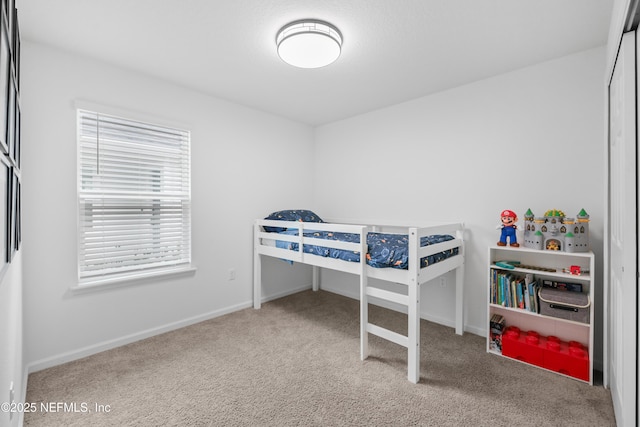 bedroom featuring carpet floors and baseboards