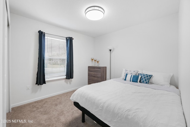 bedroom featuring carpet and baseboards