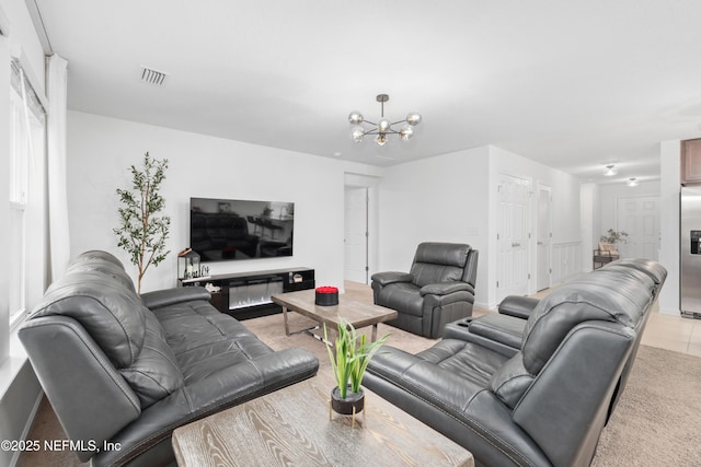 living room featuring visible vents and a notable chandelier