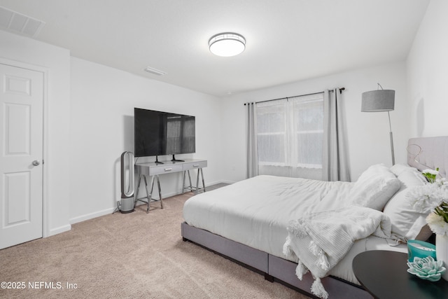 bedroom featuring visible vents, light carpet, and baseboards