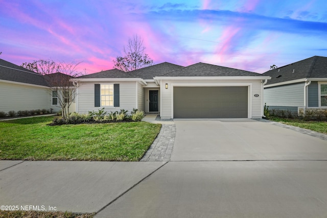 ranch-style home with a garage, a front yard, roof with shingles, and driveway