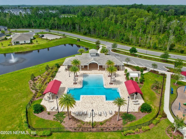 view of pool featuring a water view and a forest view